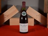 a bottle of wine sitting on a table next to wooden blocks