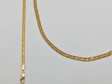 a close up of a gold chain on a white background