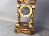 une horloge posée sur une table à côté d'un ventilateur