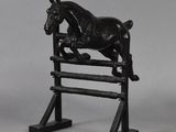 black horse jumping over a wooden fence on a gray background