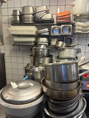 pots and pans stacked on top of each other in a kitchen