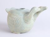 a small teapot with a handle on a white surface