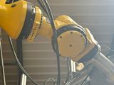 a yellow robot that is attached to a metal pole