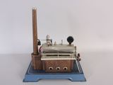 a small model of a steam engine on a blue platform