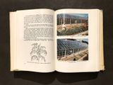 an open book on a table with a drawing of a greenhouse