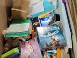 a cardboard box full of books and other items