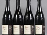 four bottles of wine are lined up on a table