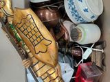 a cardboard box filled with various items and a gold statue