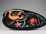 an image of a black oval shaped object with flowers on it