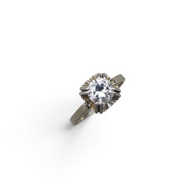 a close up of a diamond ring on a white surface