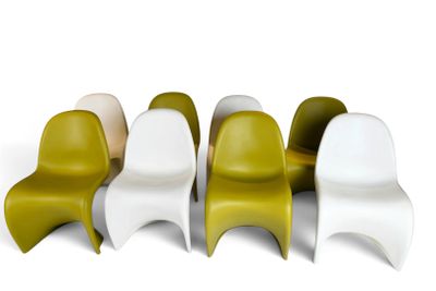 four different colored plastic chairs are lined up in a row