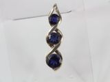 a close up of a pair of earrings with blue stones