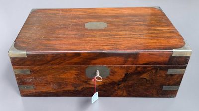 a small wooden box with a tag on it