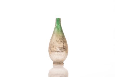 a glass bottle that is sitting on top of a table