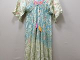 a dress hanging on a hanger against a wall