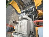 the back end of a yellow bulldozer with a hose attached to it