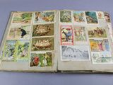 an open book with pictures of people and animals on it
