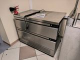 a stainless steel oven sitting on top of a tiled floor