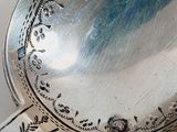 a close up of a silver spoon on a table