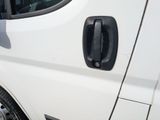 a white van with a black door handle on the side of it