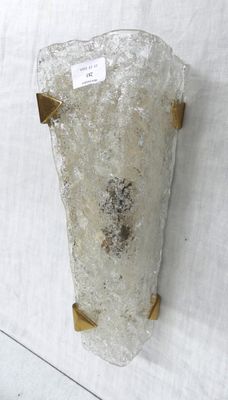 a large piece of glass on the wall with a tag on it