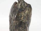 sculpture of a bird on a rock on a white background