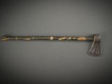 an old axe with a wooden handle sitting on top of a table