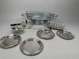 a lot of silver plates and silverware on the table