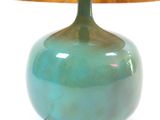 a green lamp that is sitting on a table