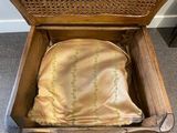 a wooden box with a cloth inside of it on the floor