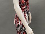 a mannequin wearing a black and red dress with red flowers on it
