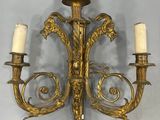 pair of antique brass wall sconces with two candles on each of them