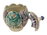 an image of a decorative vase with a flower on it