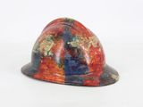 a red and blue helmet on a white surface