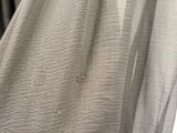 a close up of a curtain with a hole in the middle of it