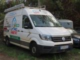 a white van that is parked in the grass