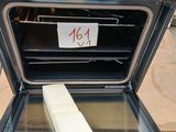 a person putting a piece of butter into an oven