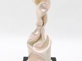statue of a woman in a flowing white dress on a black base