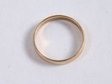 a close up of a gold ring on a white surface