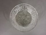a clear glass bowl with a star design on it