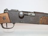 an old rifle with a wooden barrel and a metal handle