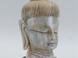 a close up of a statue of a person with a bun on his head