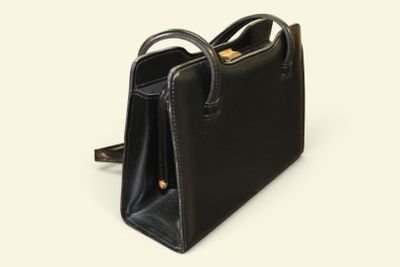 black leather handbag on white background with clipping for the handle