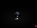 a close up of a blue diamond sitting on top of a black surface