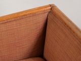a brown couch with a wooden frame on it