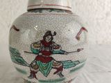 a white vase with a picture of a man on it