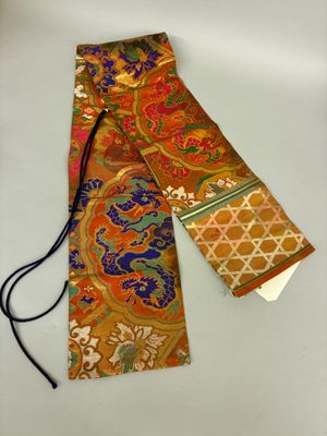 a close up of a tie on a white surface