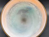 a bowl that is sitting on a table with a black background