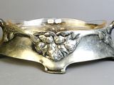 a silver plate with a bunch of grapes on it