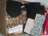 a cardboard box filled with clothes and other items